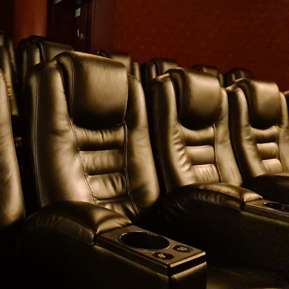 Leather movie theater seats with cup holders.